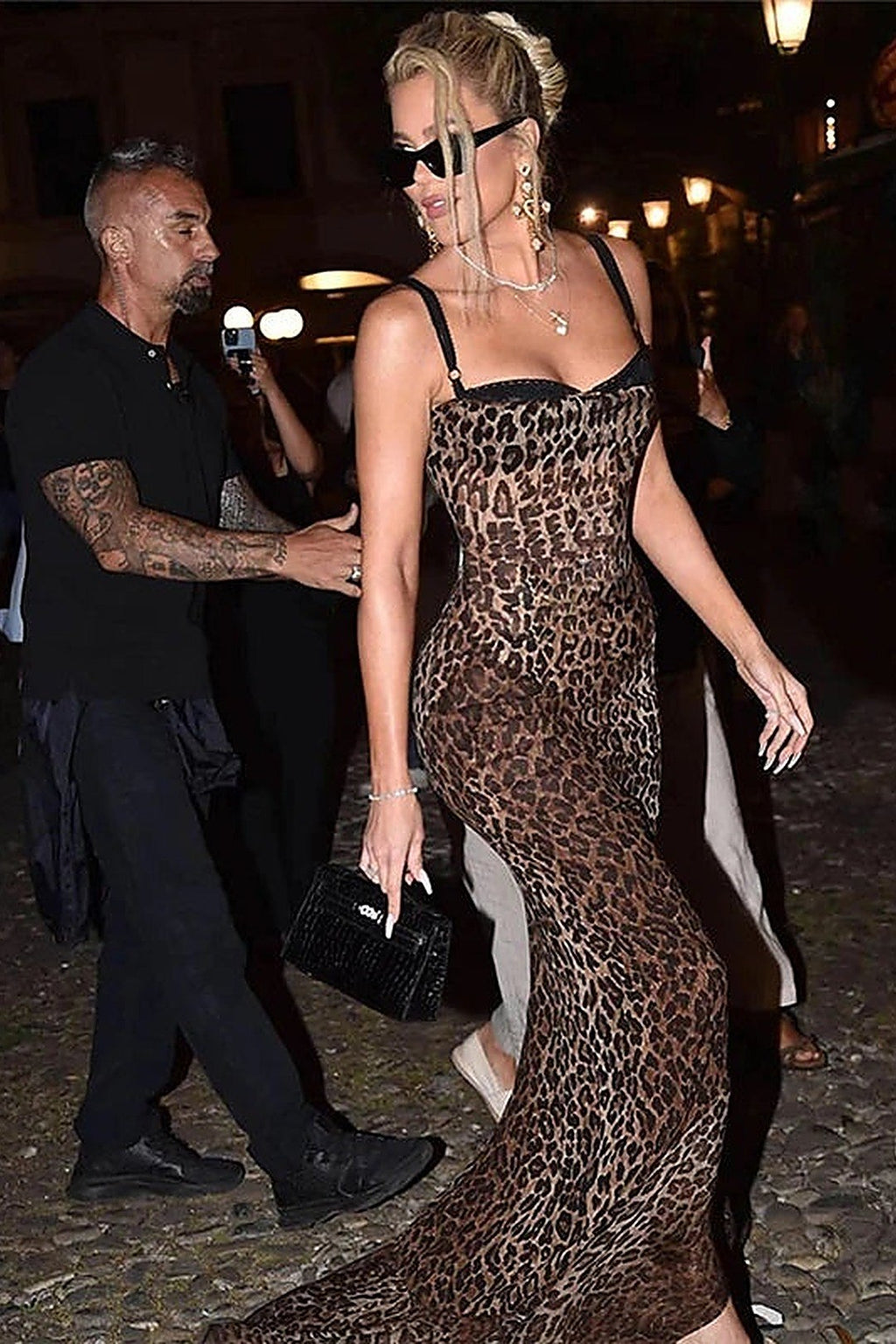 Cannes leopard maxi dress mid-stride arriving at an event, structured black handbag in hand — Amavé.